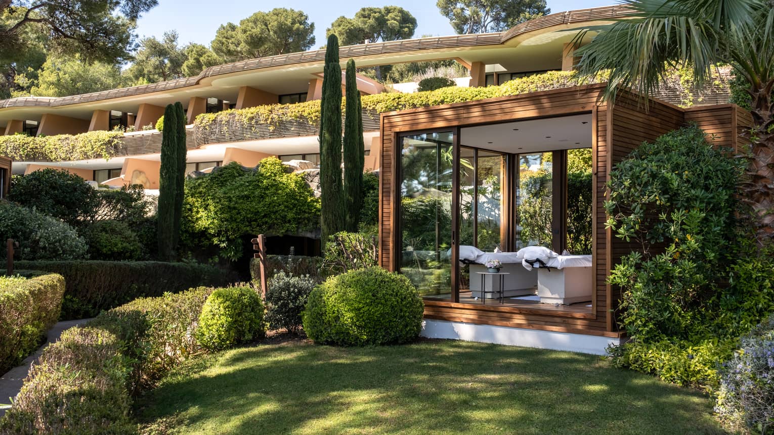 An outdoor spa treatment space set in a verdant landscape