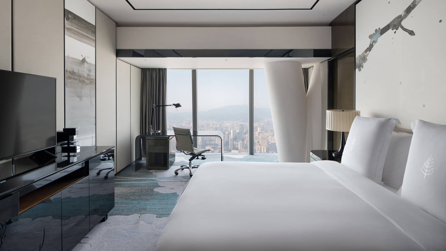 Tower King City View Room with cream and blue accents, desk by floor-to-ceiling window with natural light