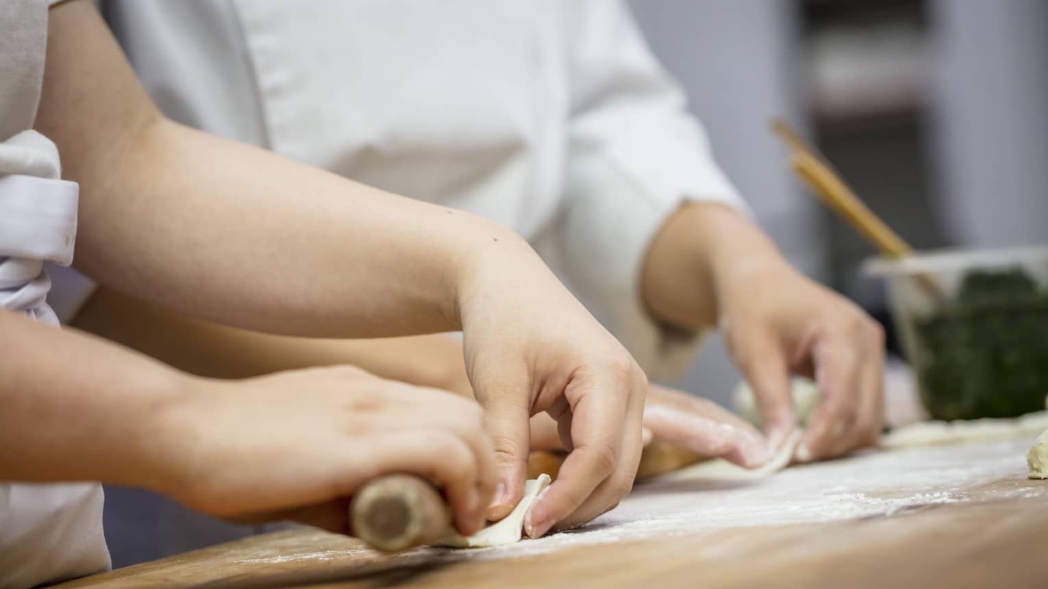View of hands rolling dumplings at Jin Sha Dim Sum class