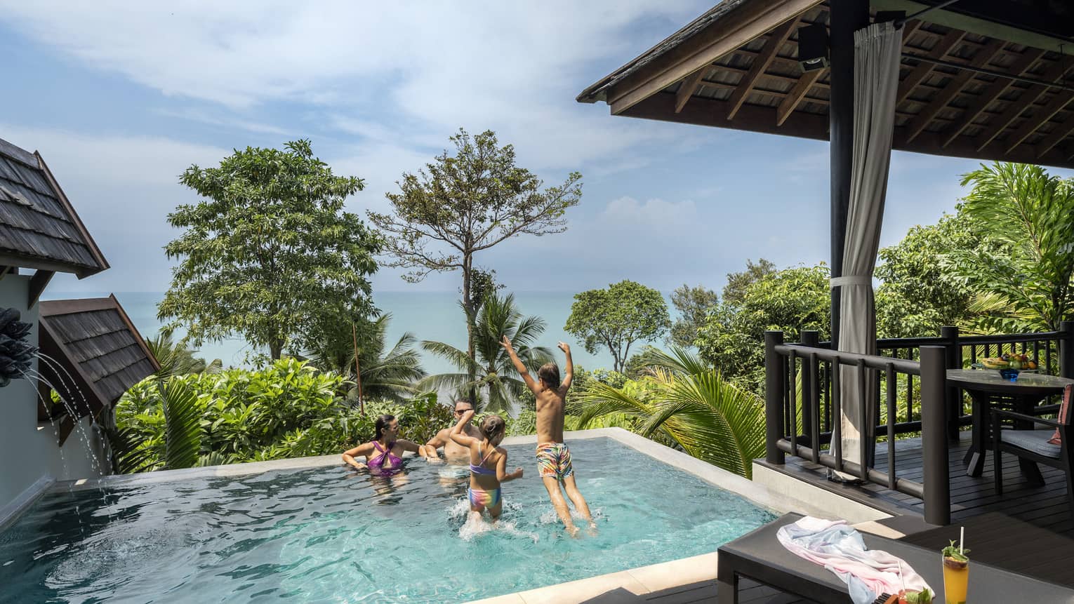 Family of four play in small pool of private pool