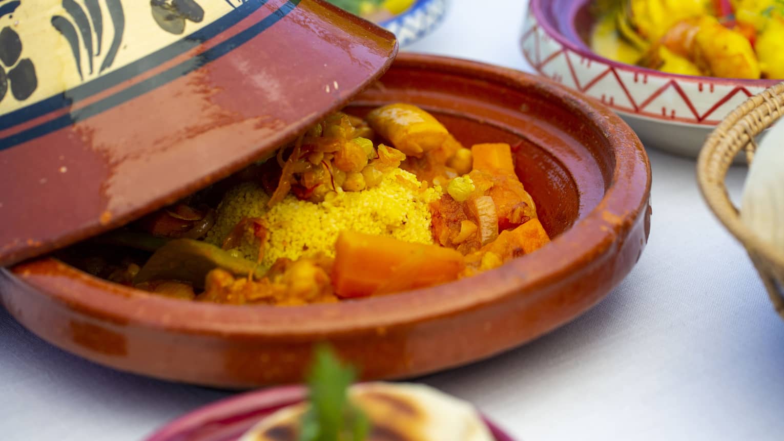 A close up of a vegetable dish in a terracotta plate with cover at Al Barakat