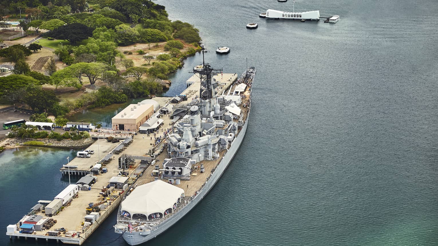 Aerial view of large battleship, people on dock at Battleship Missouri Memorial at Pearl Harbor