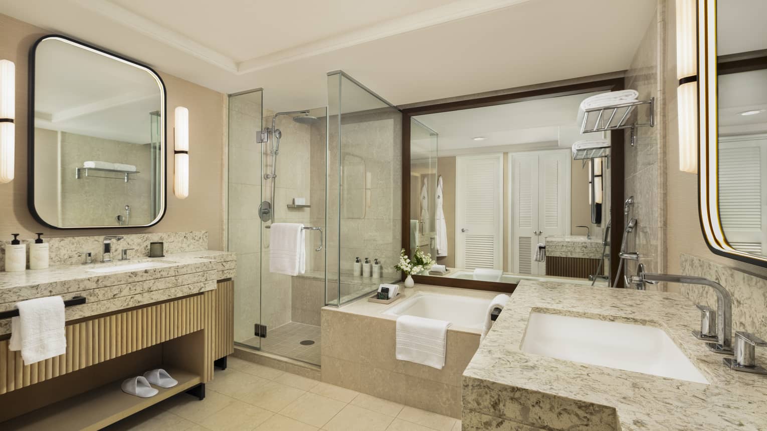 Large bathroom with two vanities, glass shower and separate tub