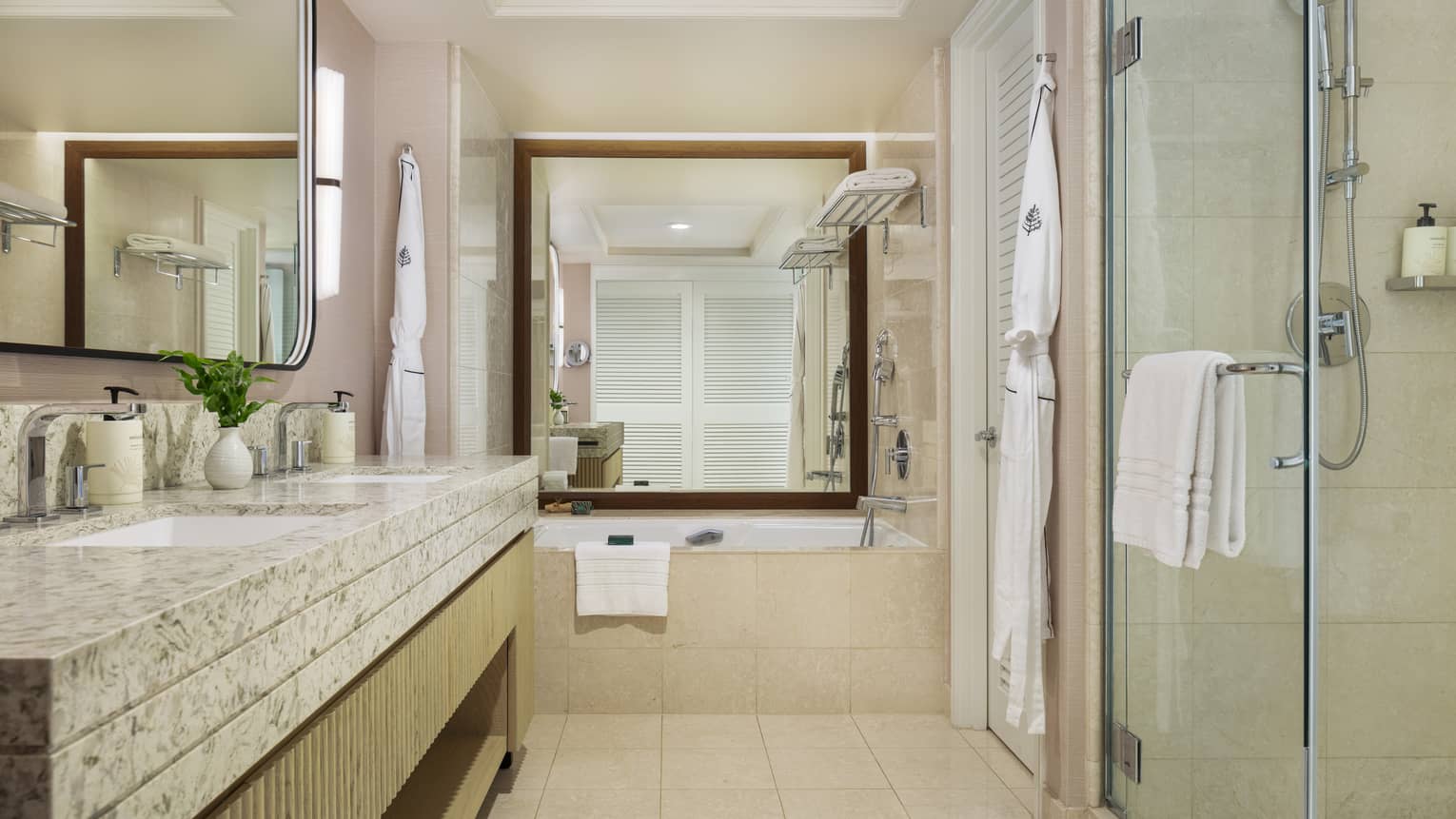 Bathroom with a glass shower and separate tub next to a large mirror