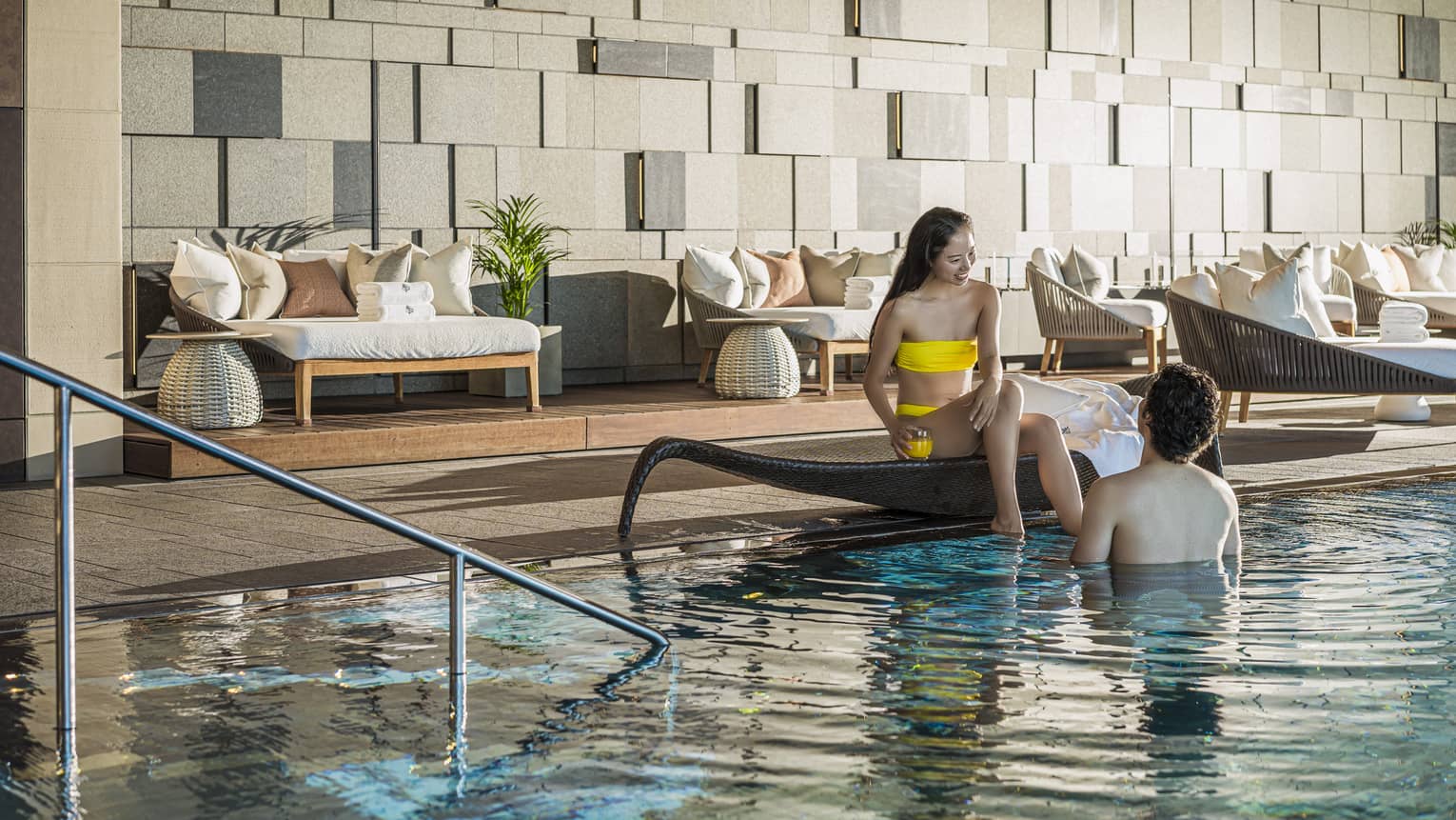Couple relaxes poolside at the indoor pool