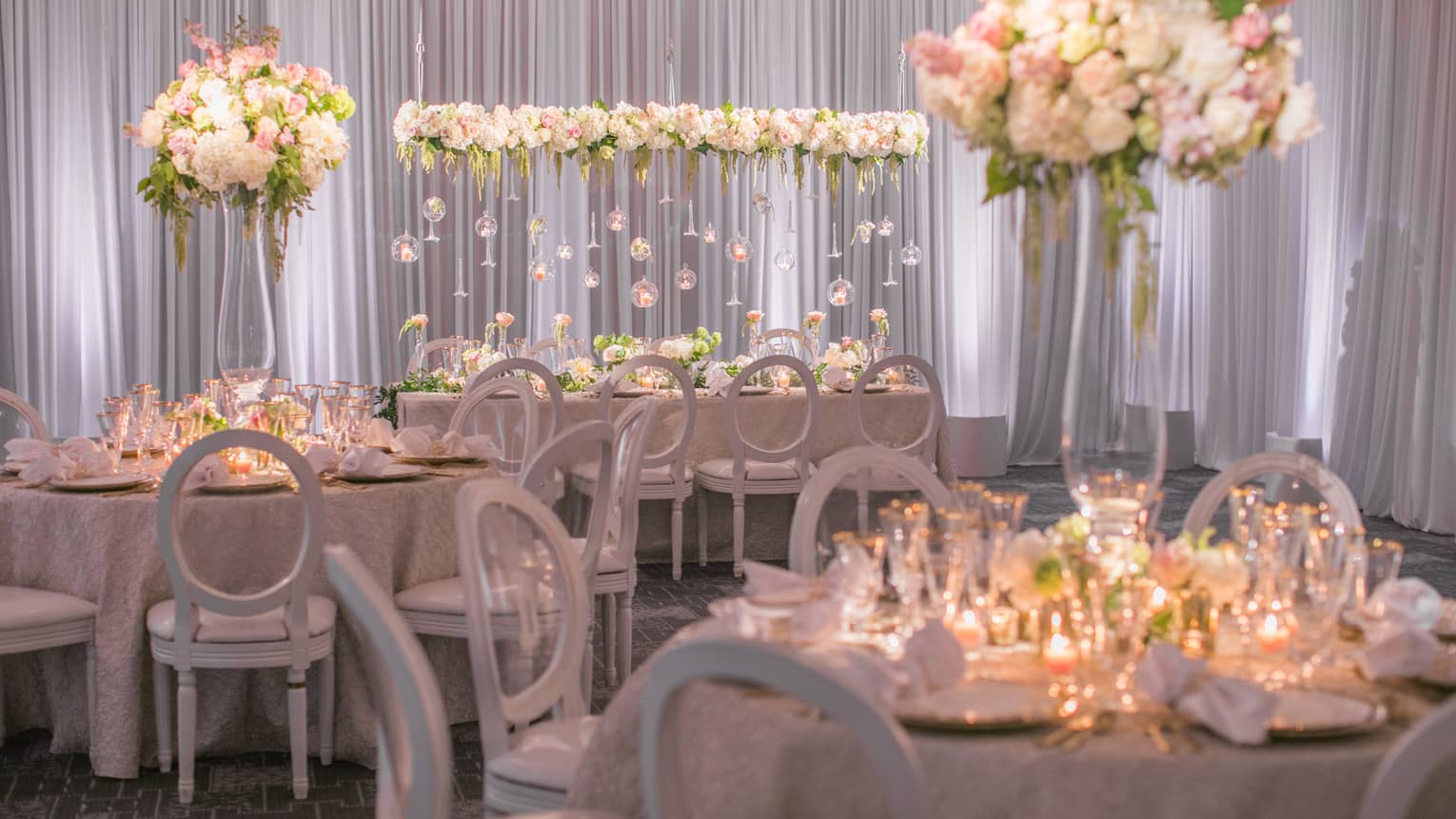 Flagler Ballroom wedding banquet with candle-lit tables, white flowers and glass bulb displays