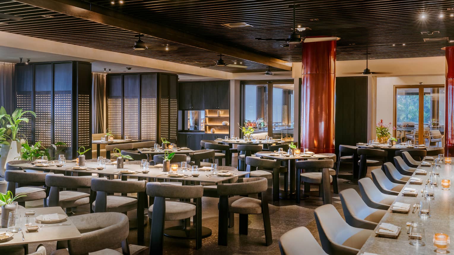 Indoor restaurant featuring long tables with grey chairs