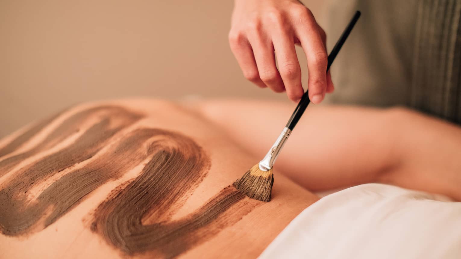 A spa treatment where nutrients are brushed and massaged into the back.