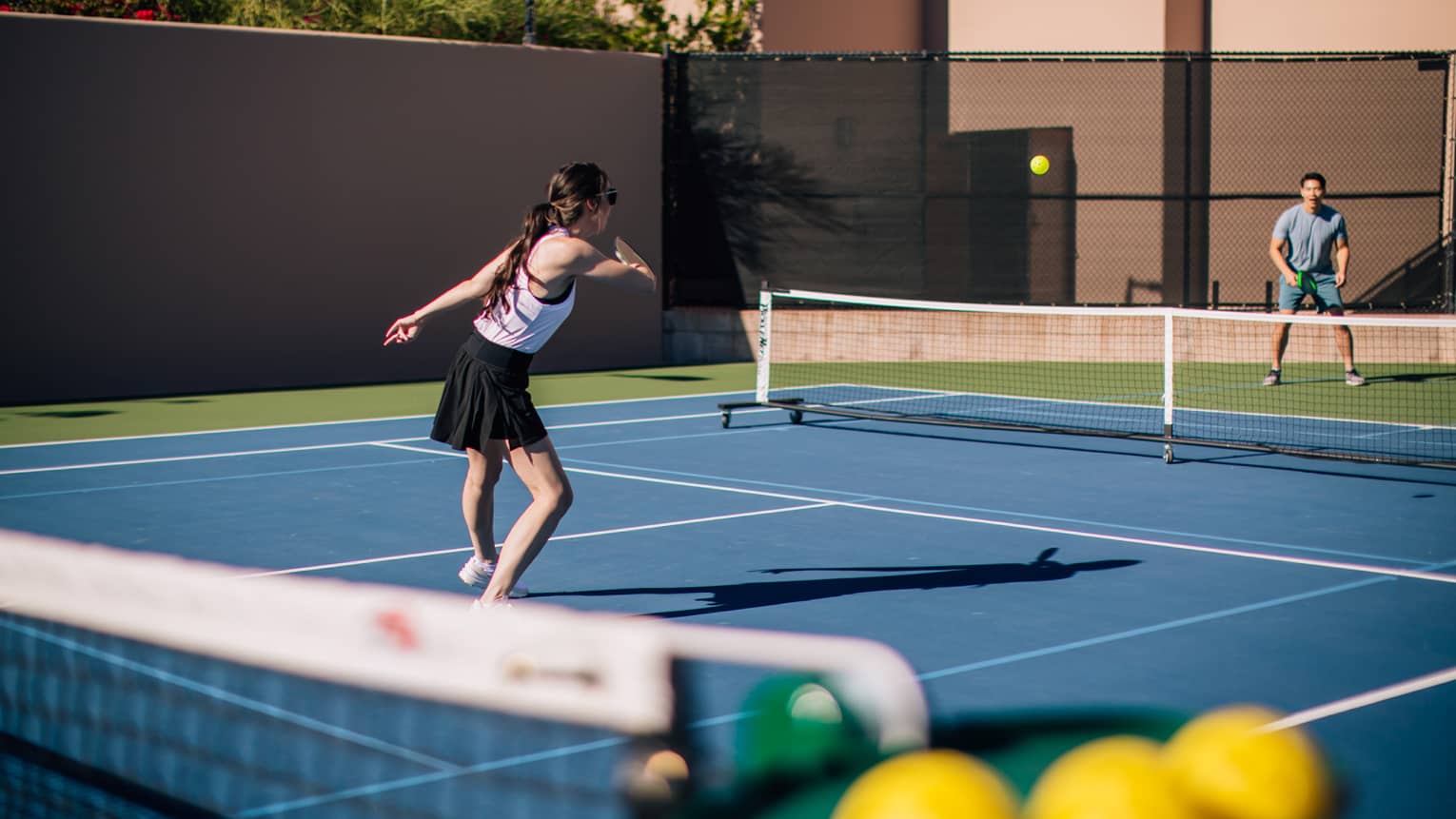 A woman and man on a tennis court.