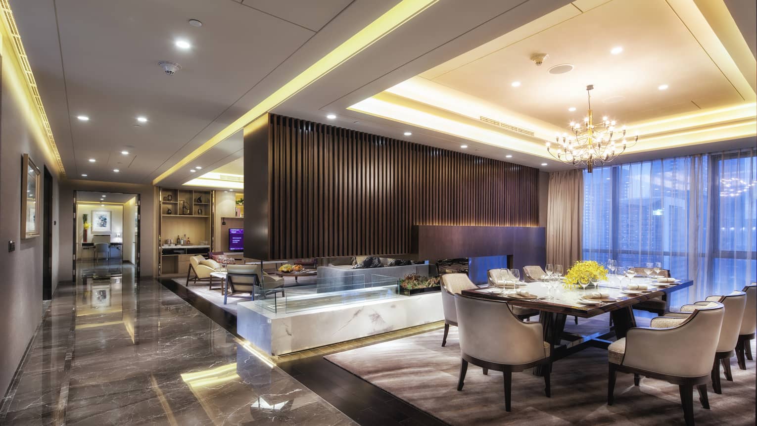 Presidential Suite large dining room, modern wood fireplace separating living room, marble floors