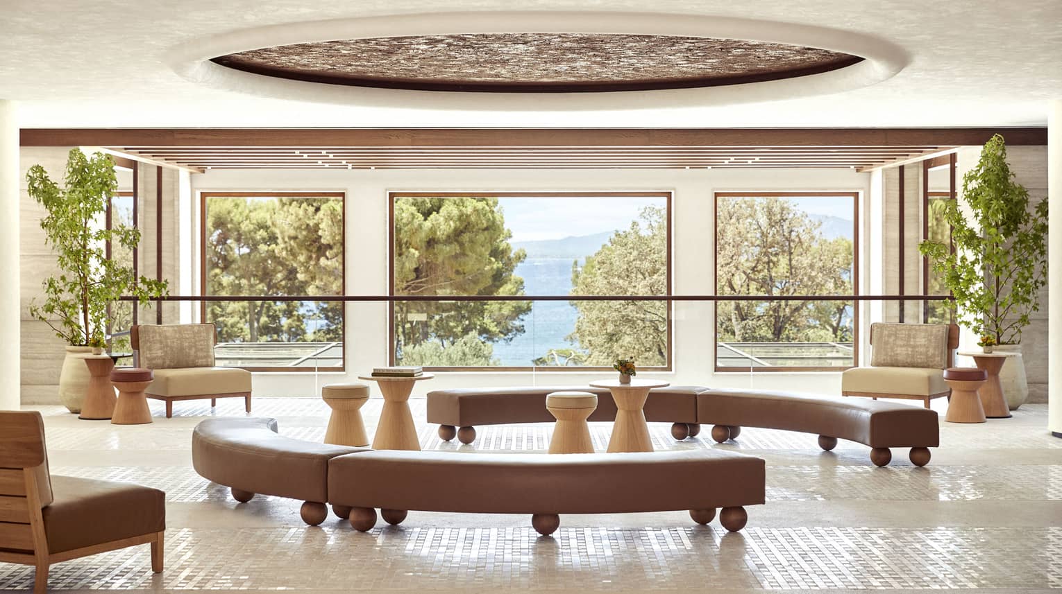 Four Seasons Resort Mallorca lobby with three picture windows looking out to pine trees and sea
