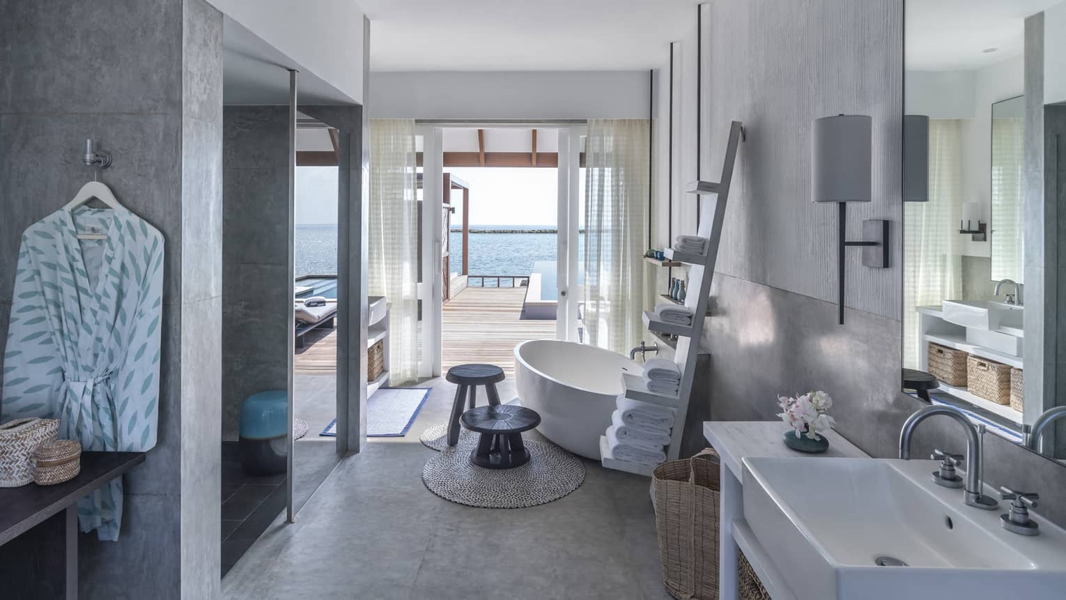 Sunrise Water Villa with Pool bathroom, large soaking tub, towel rack, doorway to deck with pool