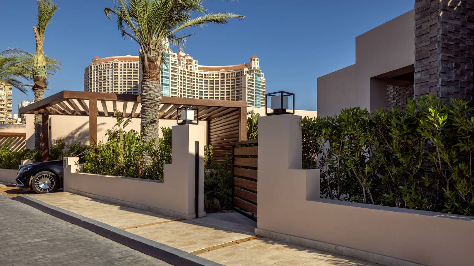 Main gate of One-Bedroom Beach Villa flanked by palm trees