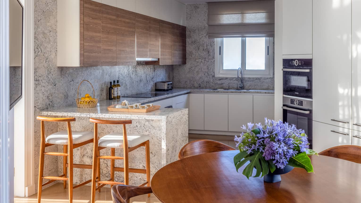 The Palace kitchen with marble countertops, round dining table, bar stools