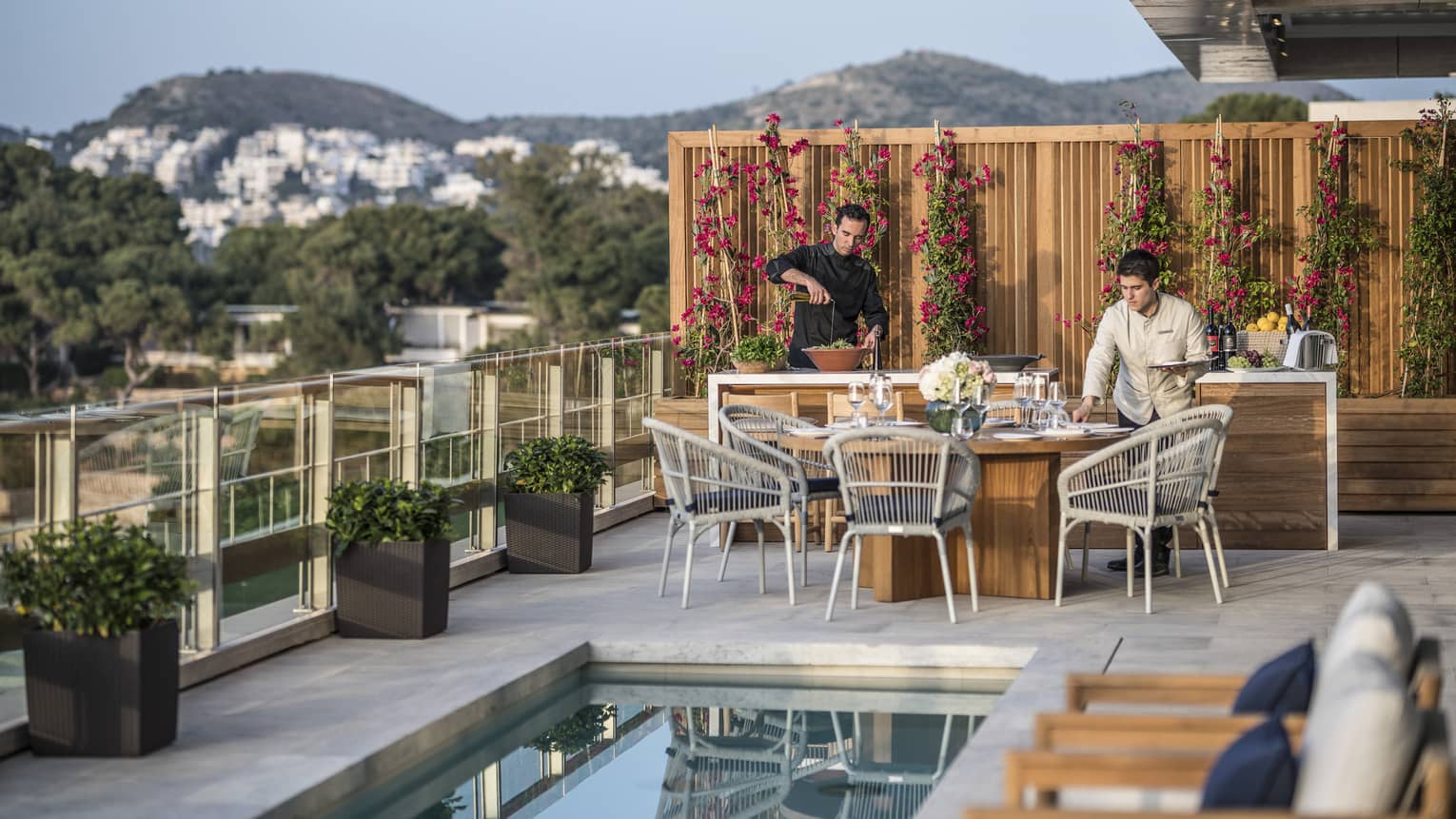 Arion Royal Suite Deck private dining, lap pool with row of lounge chairs, view of mountains and Crete in the background