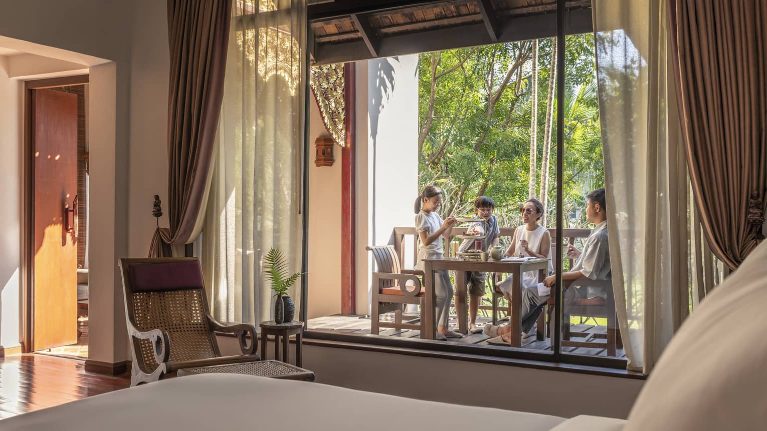 Family of four enjoys quality time on the balcony of their One-Bedroom Residence