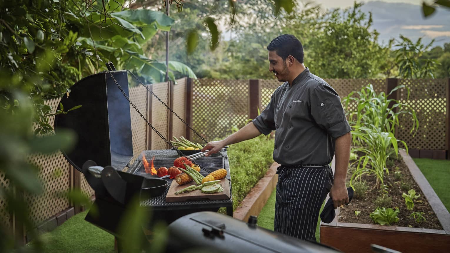 Chef grilling vegetables in the resort garden