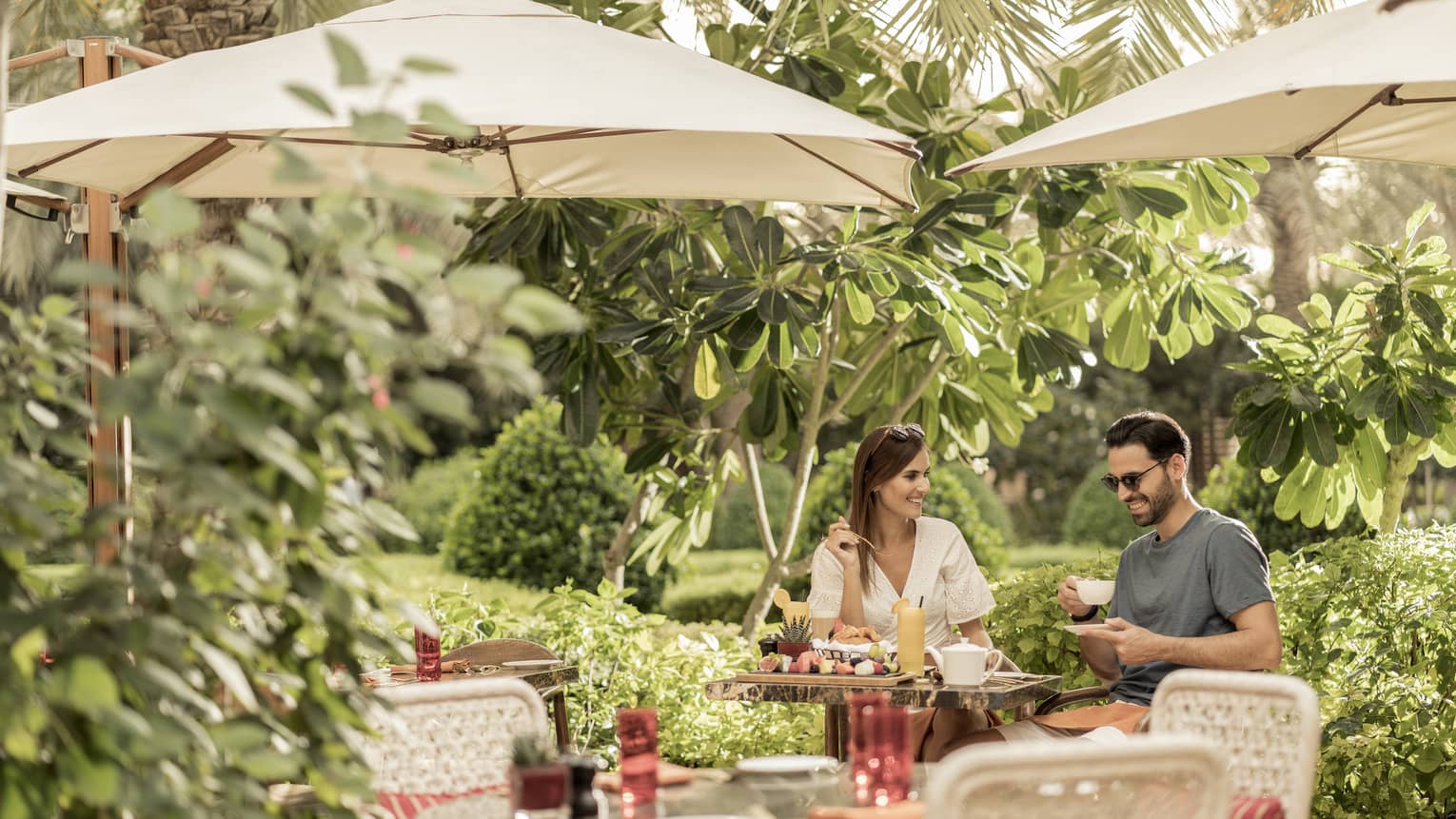 Couple dining on sunny patio at SUK Restaurant