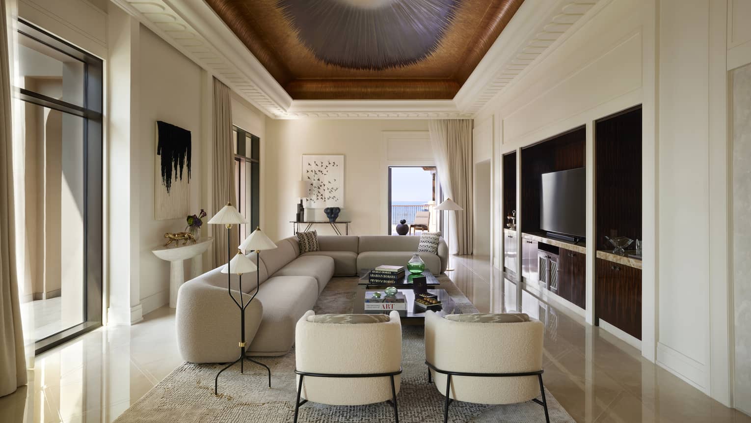 Contemporary Presidential Suite living room with taupe sofa and two arm chairs, under a painted ceiling