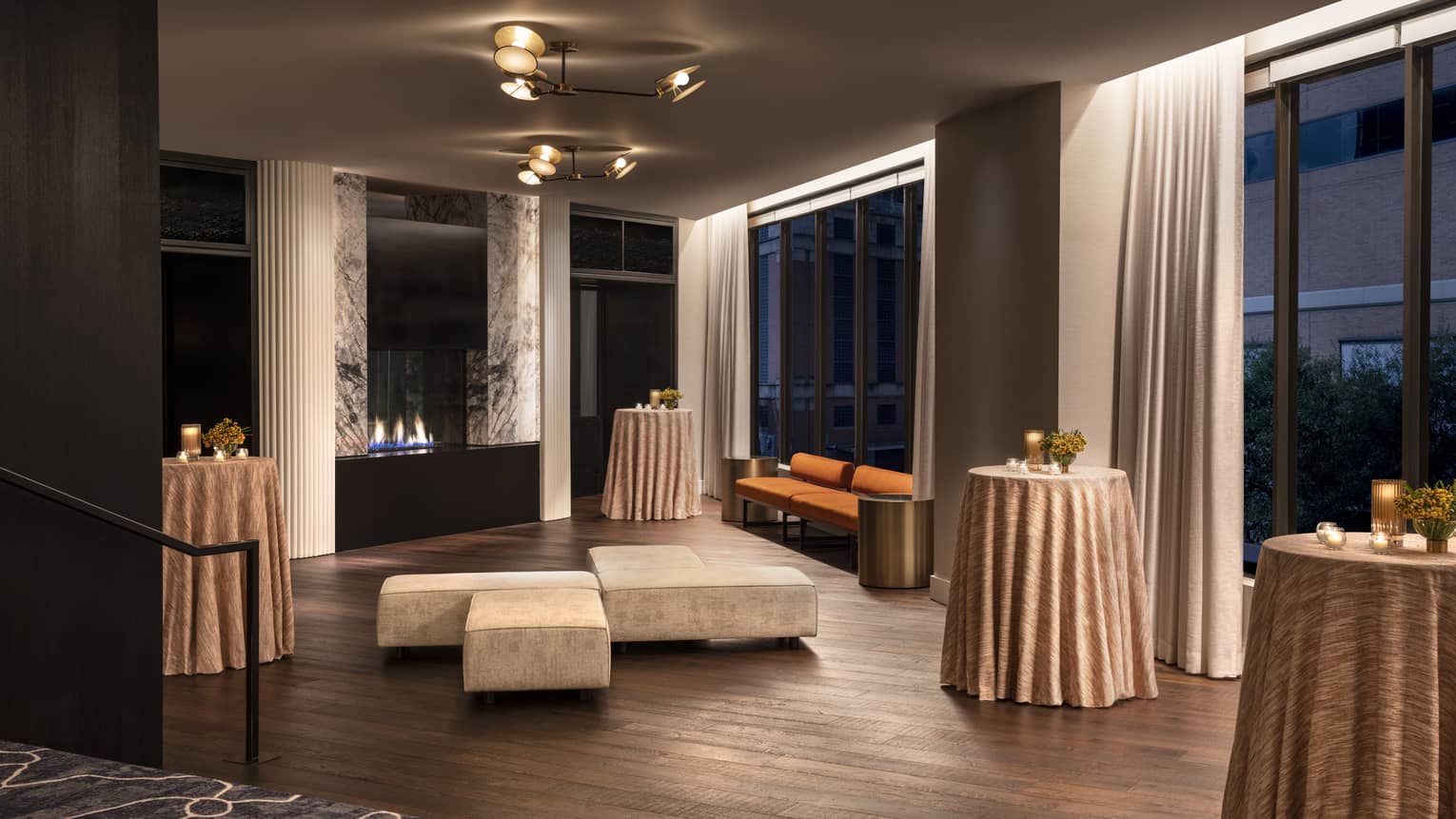 A room with small tables and seating areas.