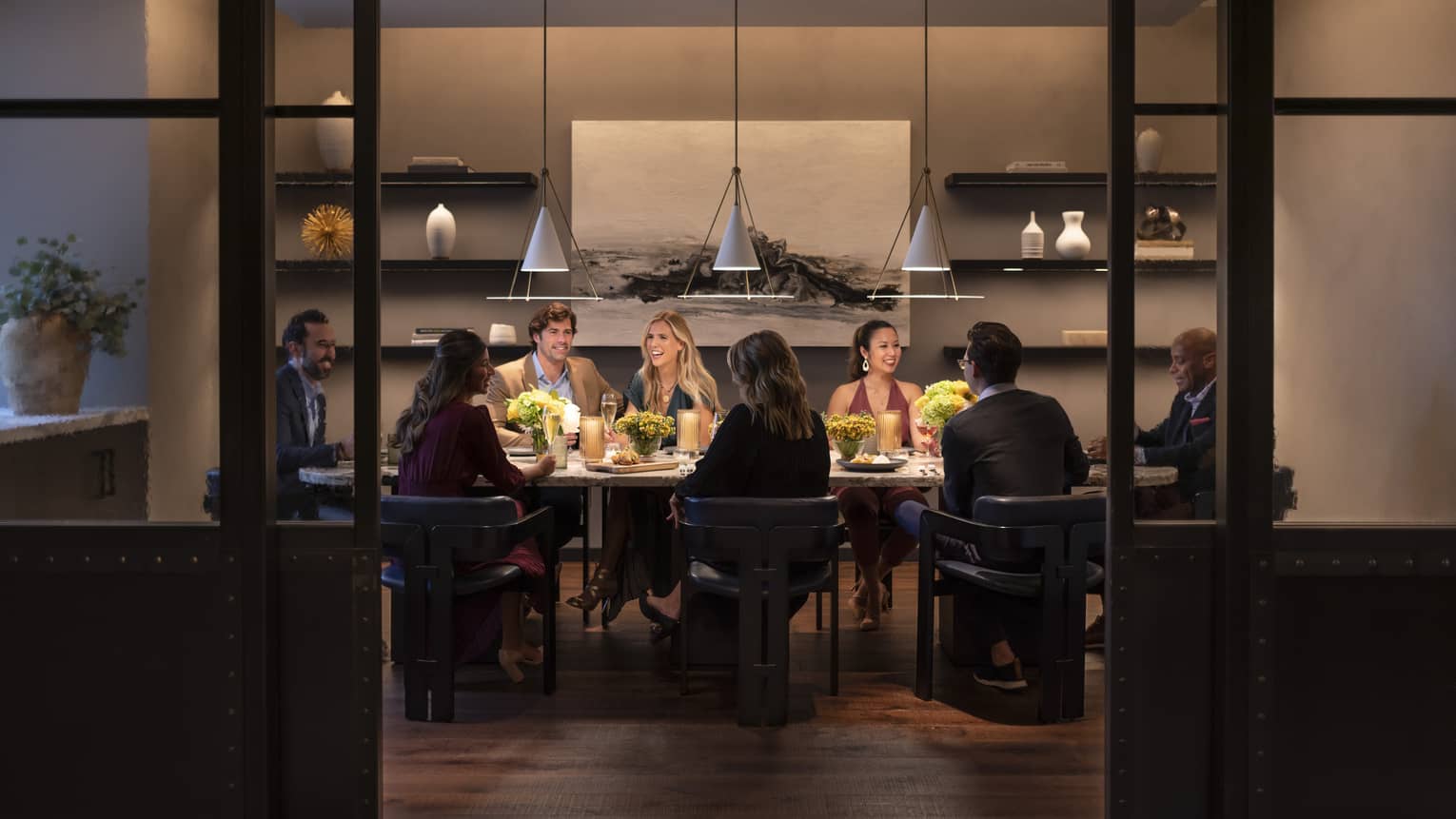 A group of people eating in a dining room.