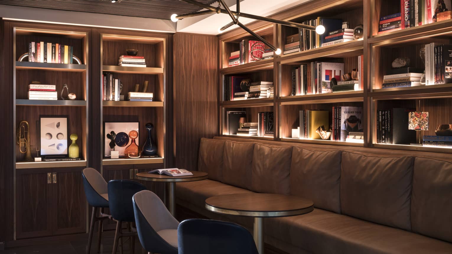 A seating area next to walls lined with bookshelves.