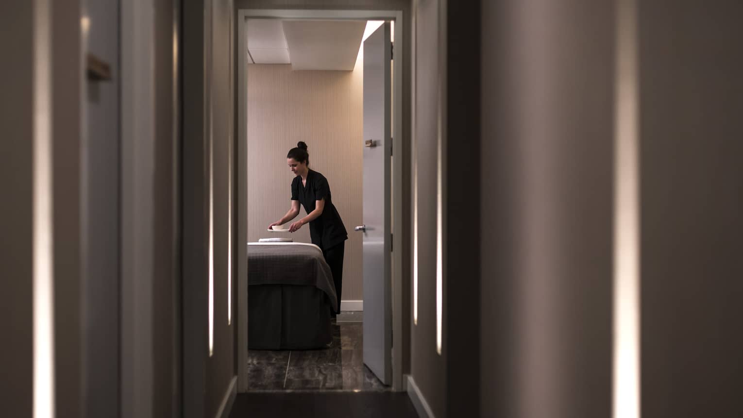 A spa team member in a spa room.
