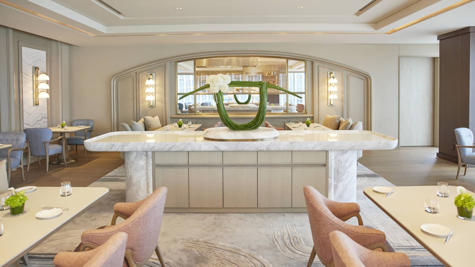 Four Seasons dining area with a marble counter and a modern floral arrangement in a light, stylish interior