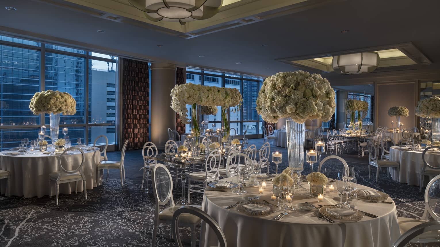 Ballroom with round banquet tables, large white floral centrepieces