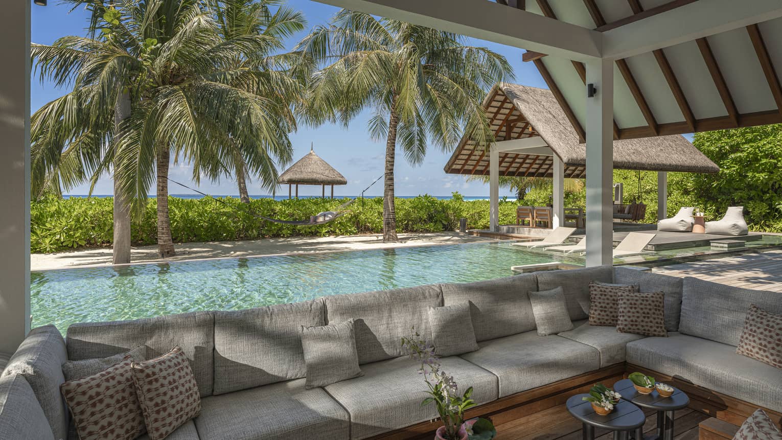 Outdoor, covered lounge by a pool