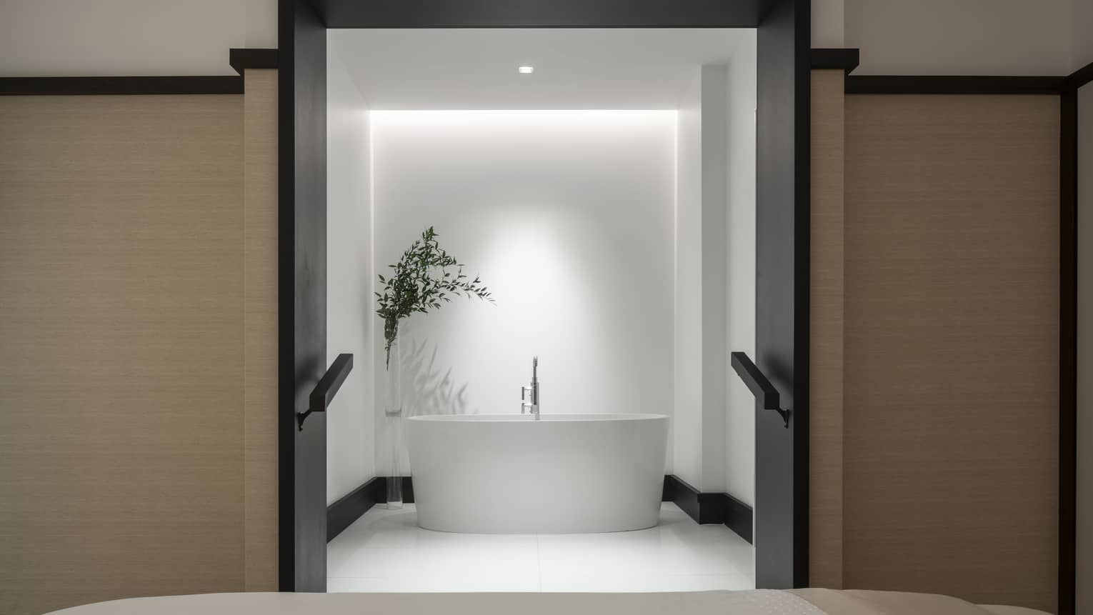 A large oval tub in the centre of a room. 