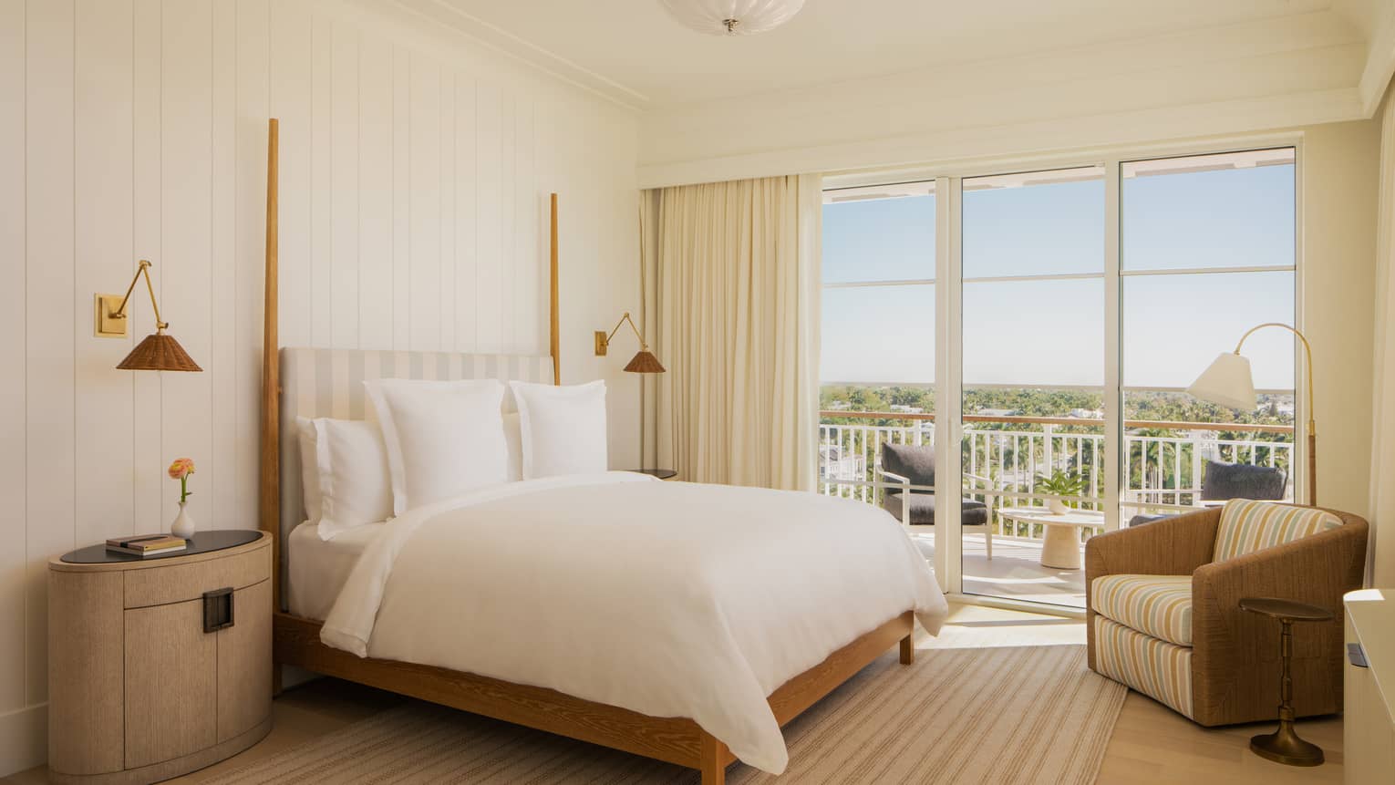 Light-filled luxury room at a resort, featuring king bed