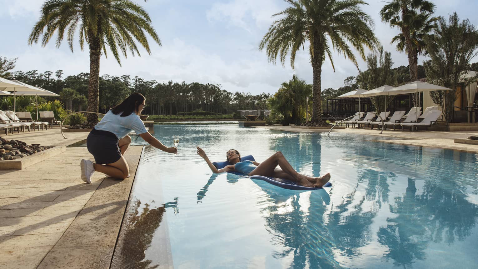 Woman enjoying a beverage in the pool