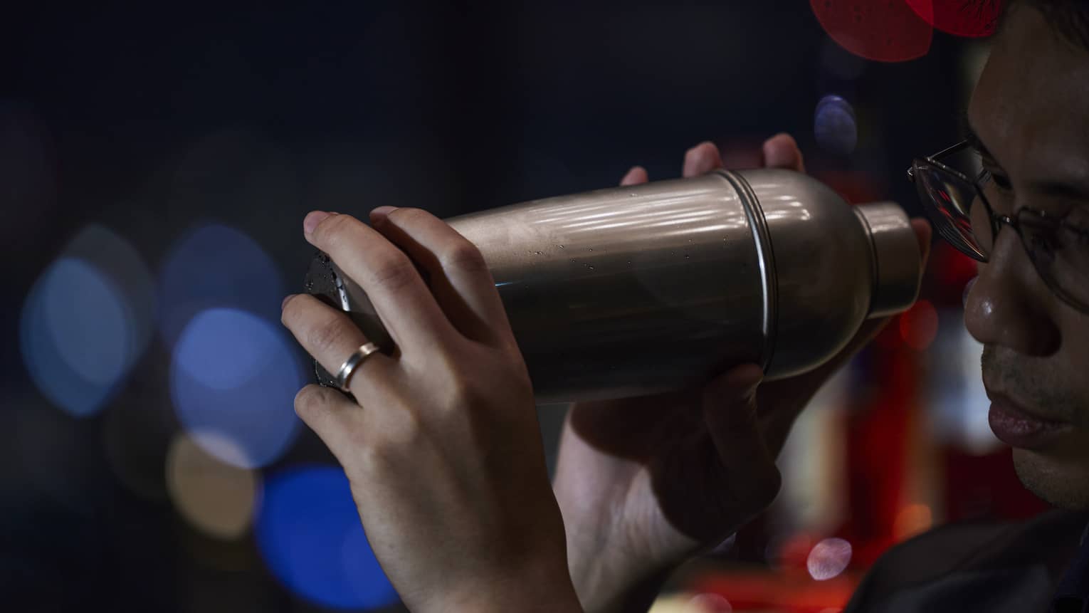 Bartender holds a cocktail shaker