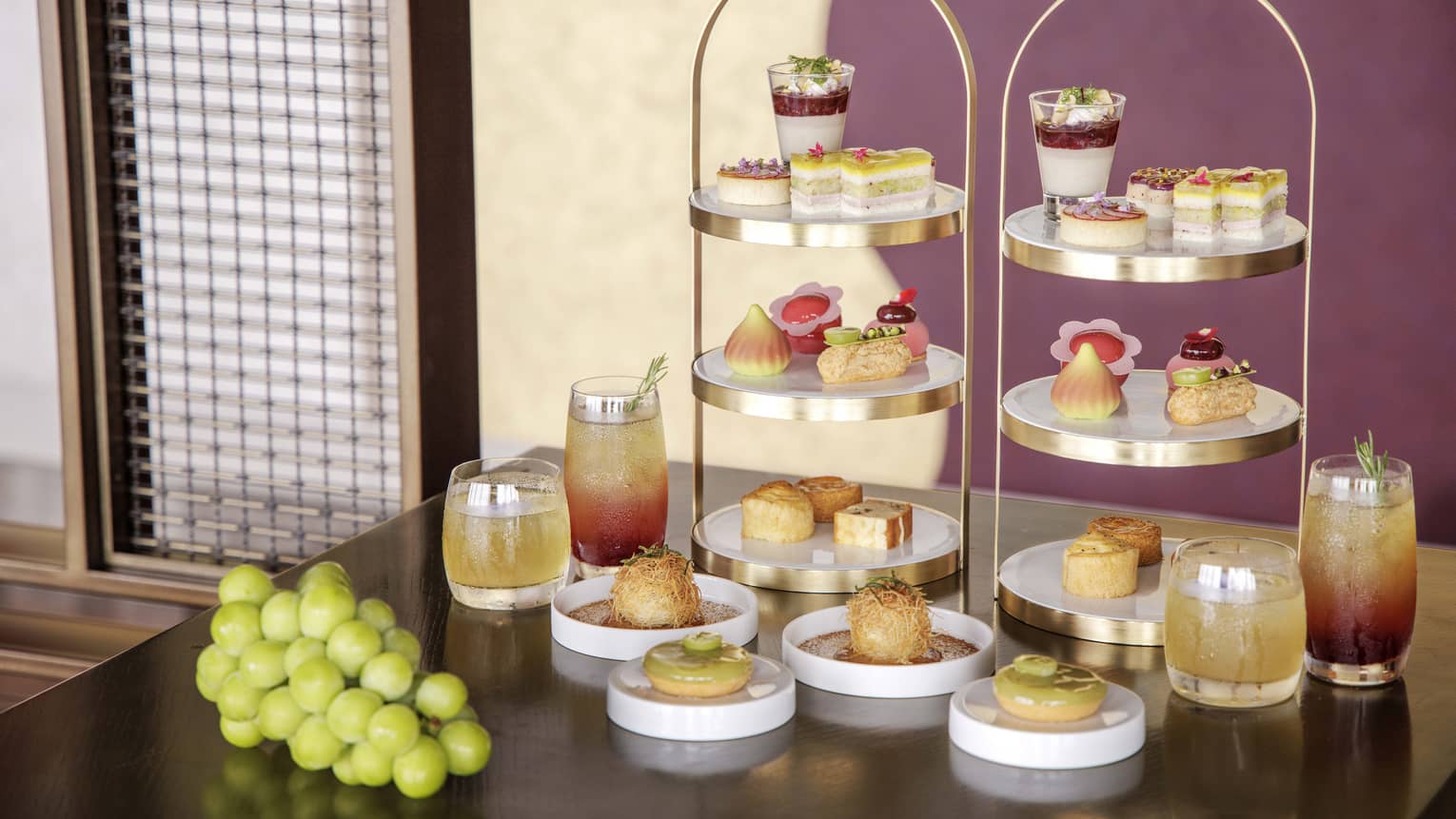 Afternoon tea spread on a table, featuring muscat grapes