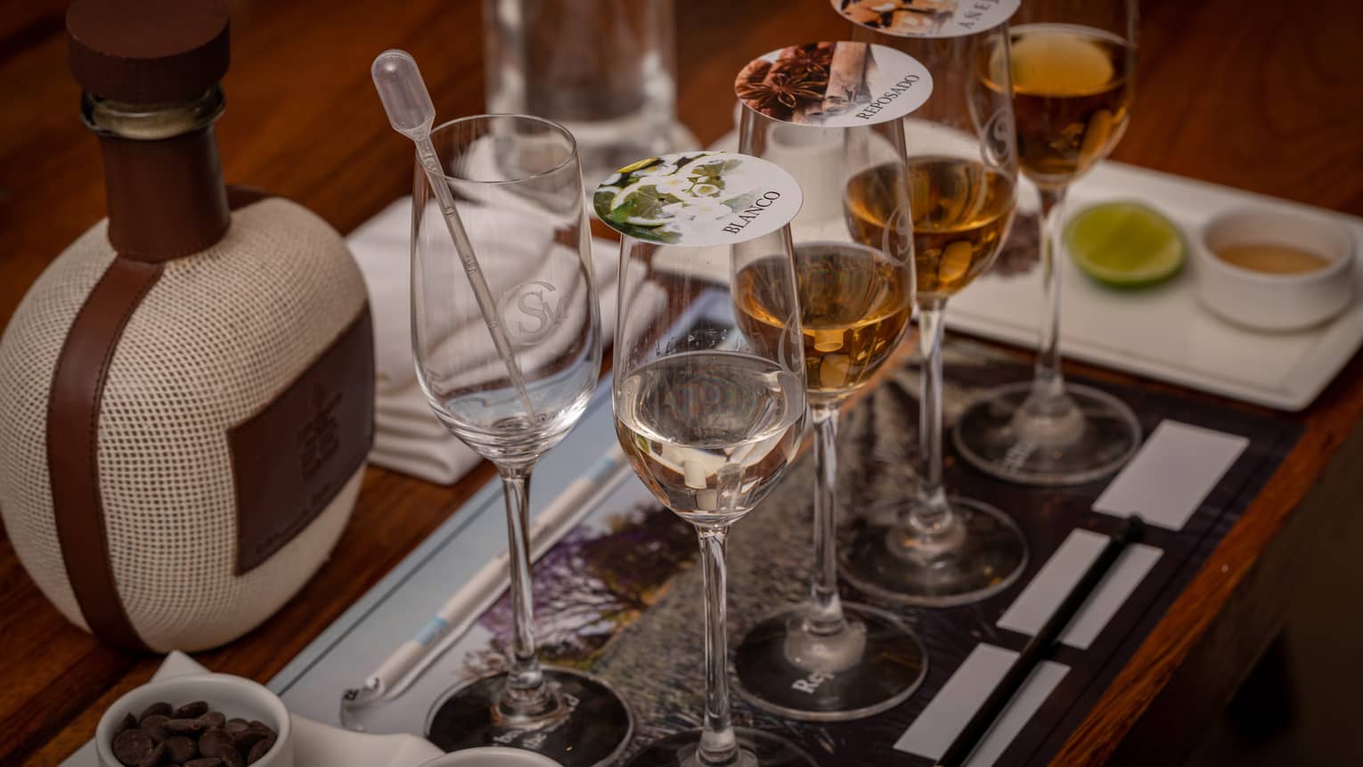 Blending tequila in glasses with covers.