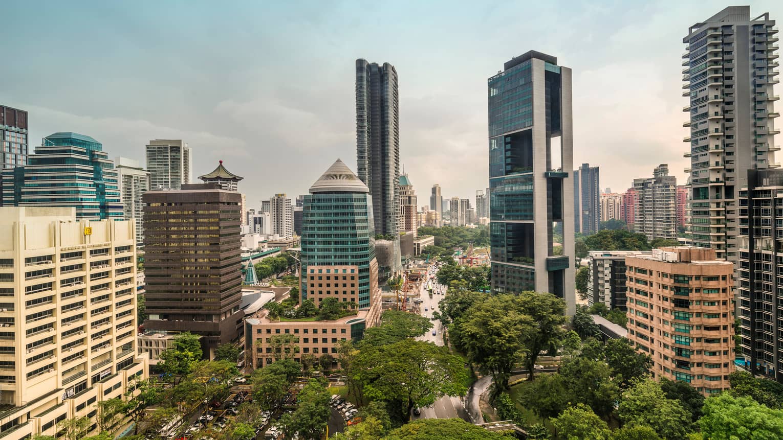Sunny Singapore skyline looking out over skyscrapers, trees