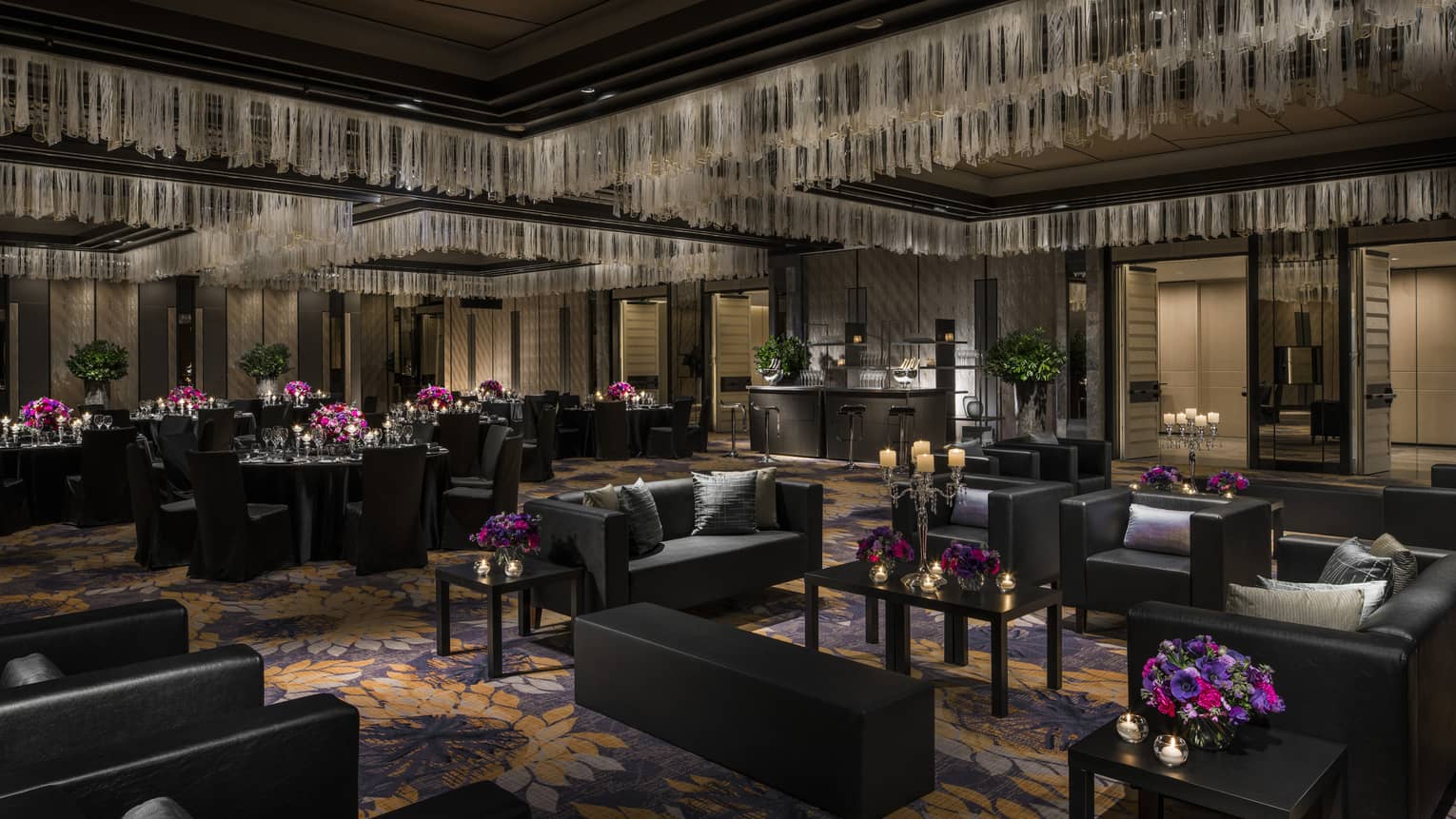 Modern Nuri Ballroom with black furniture, black dining tables, bright flowers and candles