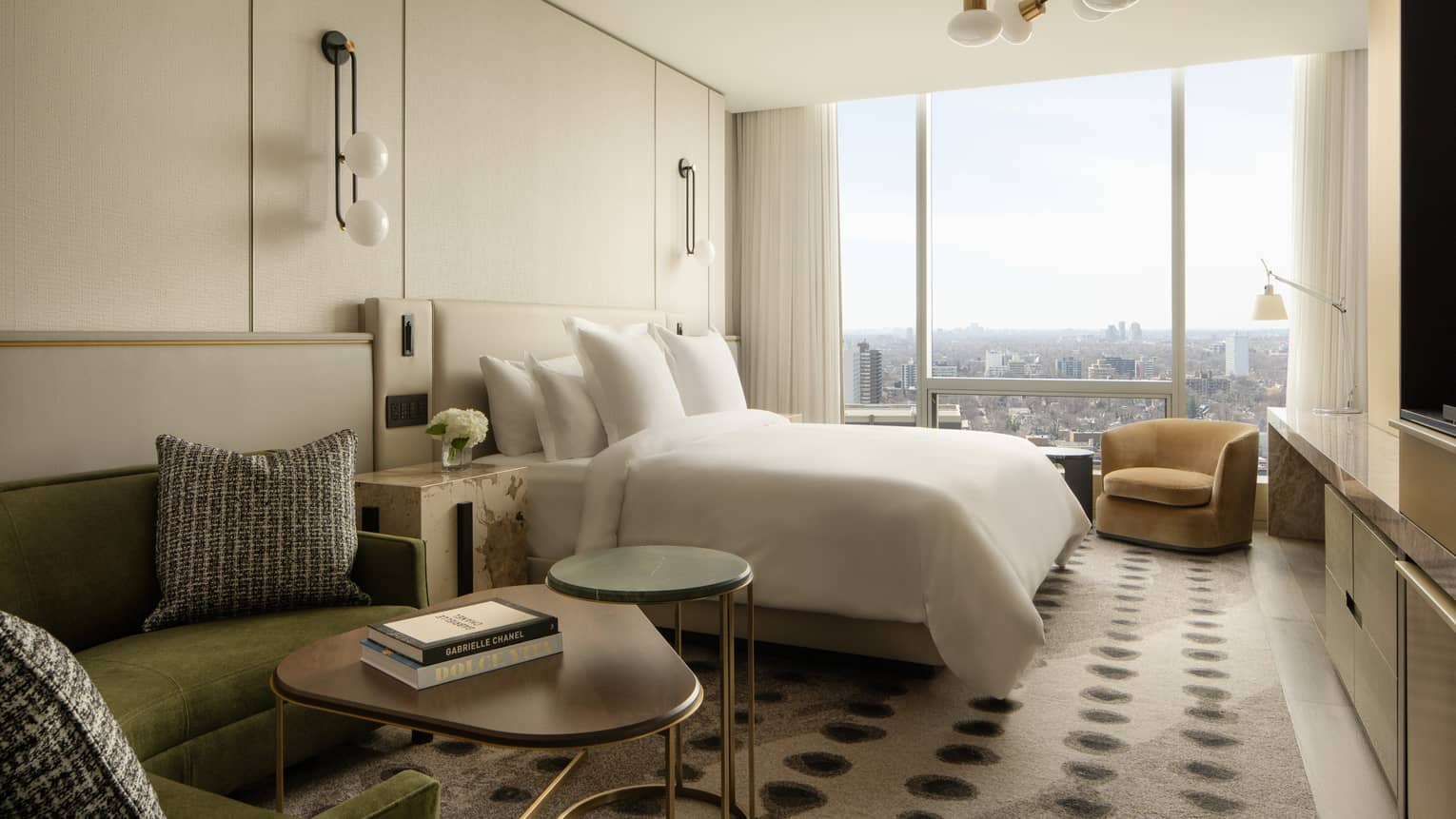 Hotel suite bedroom with king bed and wall of windows at Four Seasons Hotel Toronto