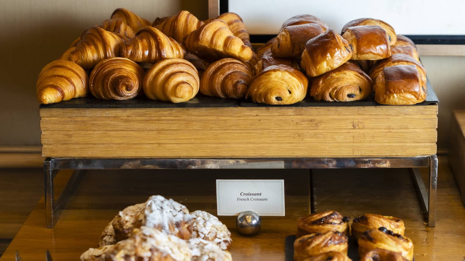 Wood display shelves hold various pastries.