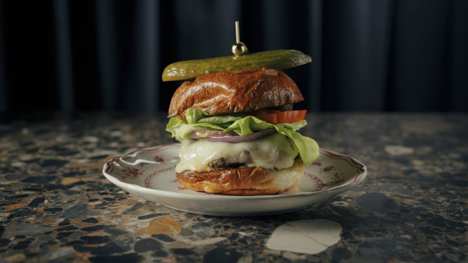 Cheeseburger topped with a pickle