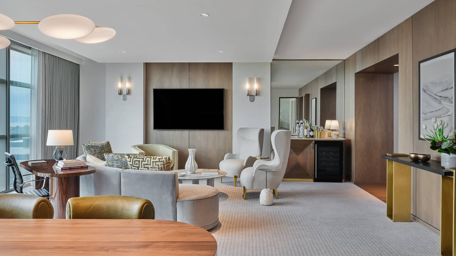 Sleek living room and dining room of hotel suite