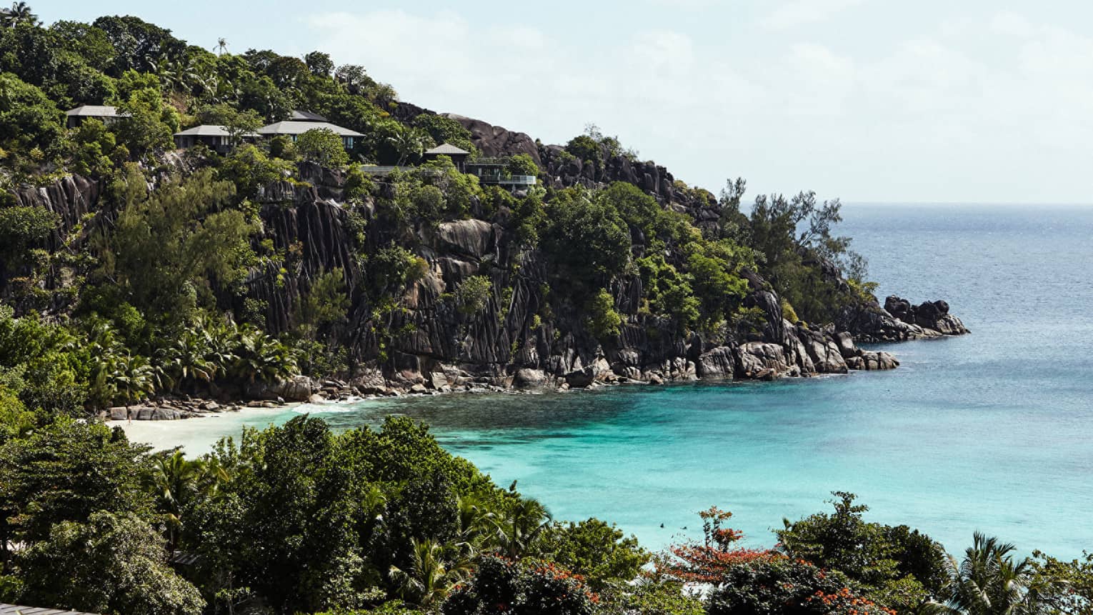 horseshoe-shaped bay surrounded by granite hillsides and green