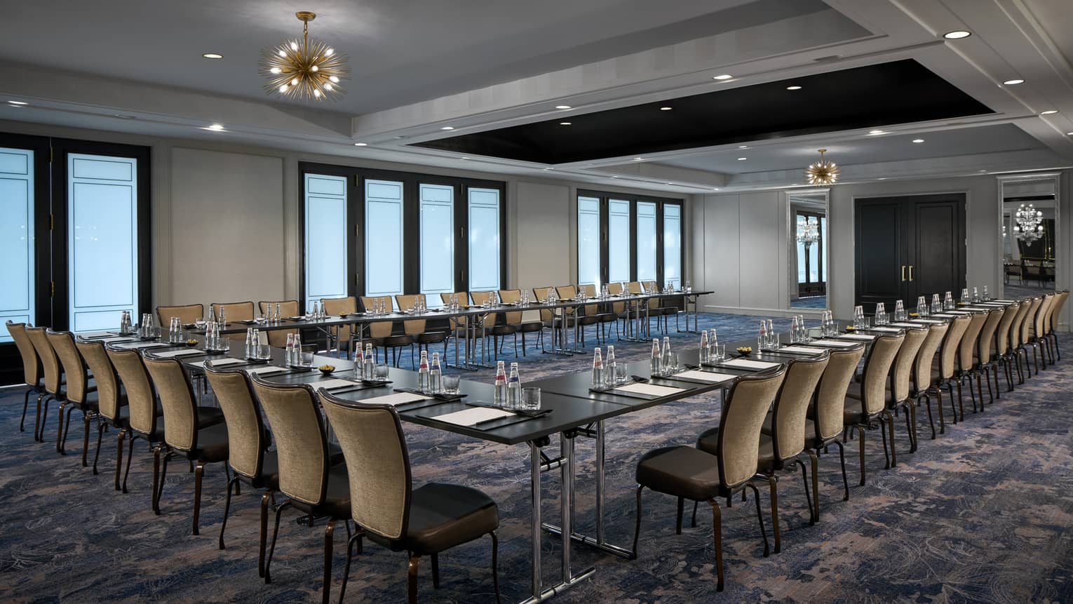 Tables and chairs with place-settings in the Dumbarton Room arranged in a U-shape