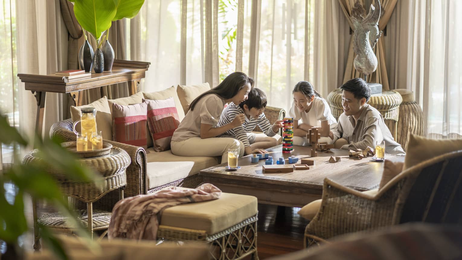 Family of four plays games in the living area of their One-Bedroom Residence