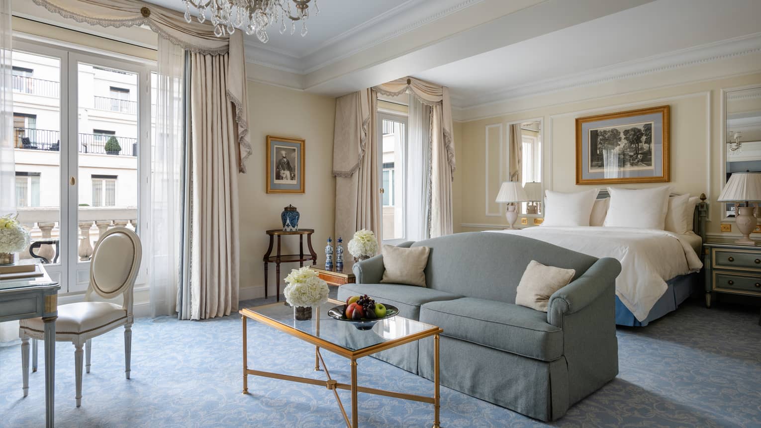 Premier room with queen bed, couch, coffee table, cream & teal Victorian accents, natural light 