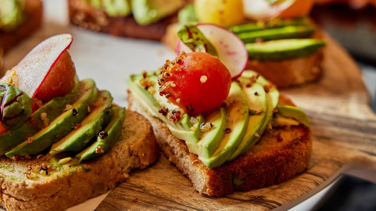 Avocado toast on a wooden tray in a luxury restaurant making the best brunch