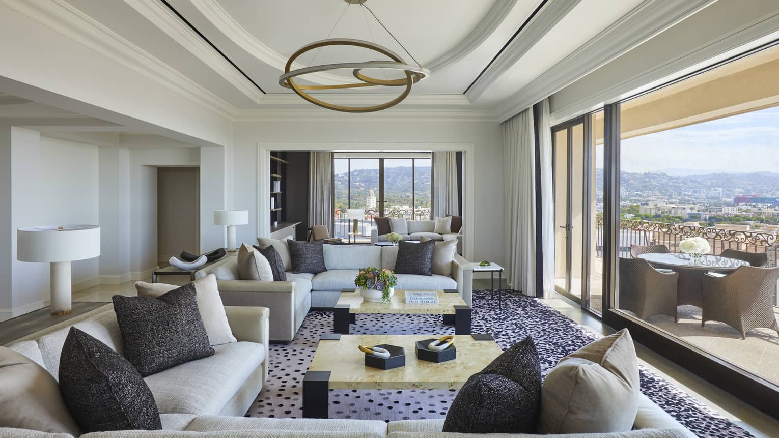 Large living room opening to city-view terrace