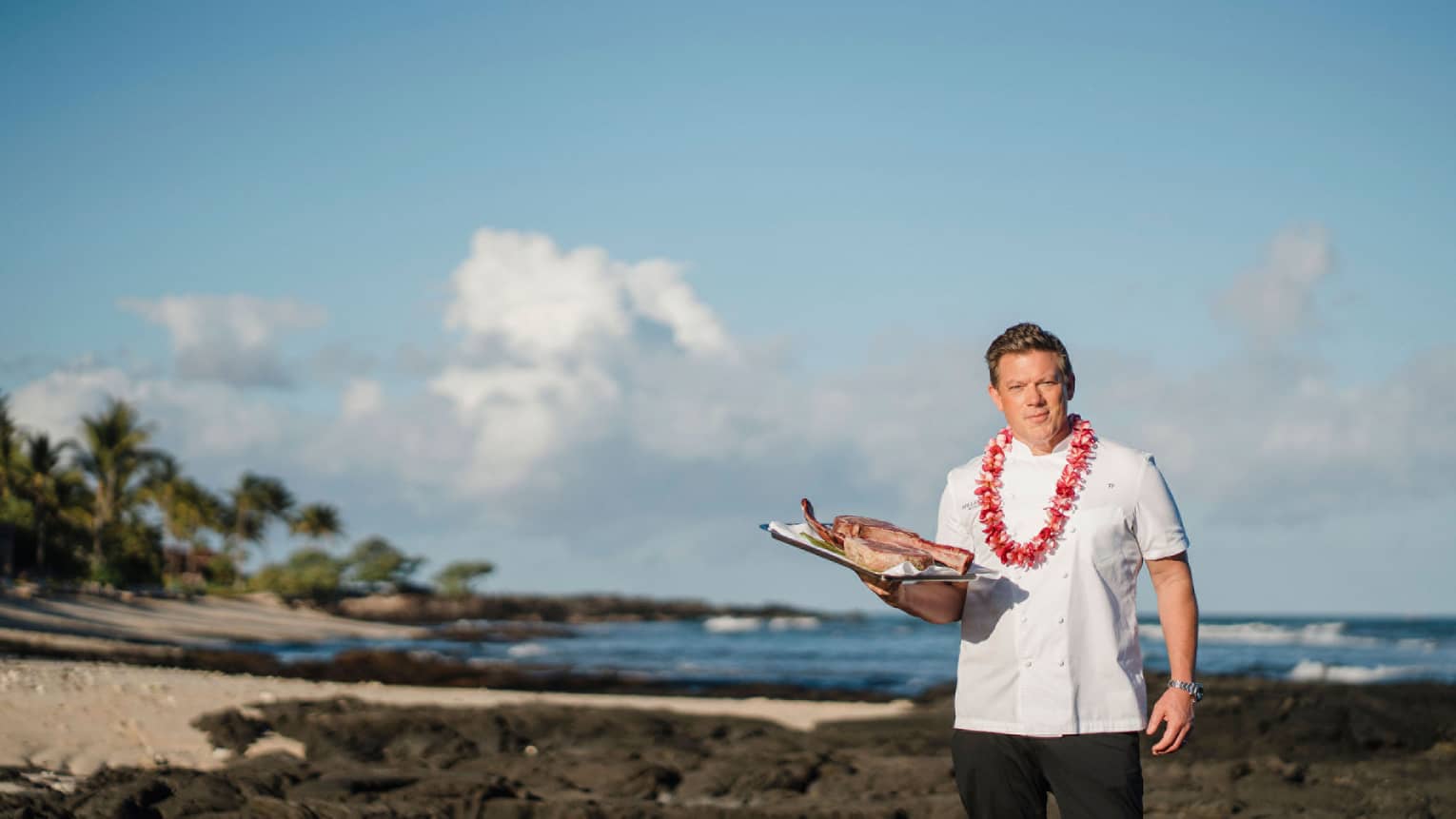 Chef Tyler Florence wears a lei on the beach in Hawaii
