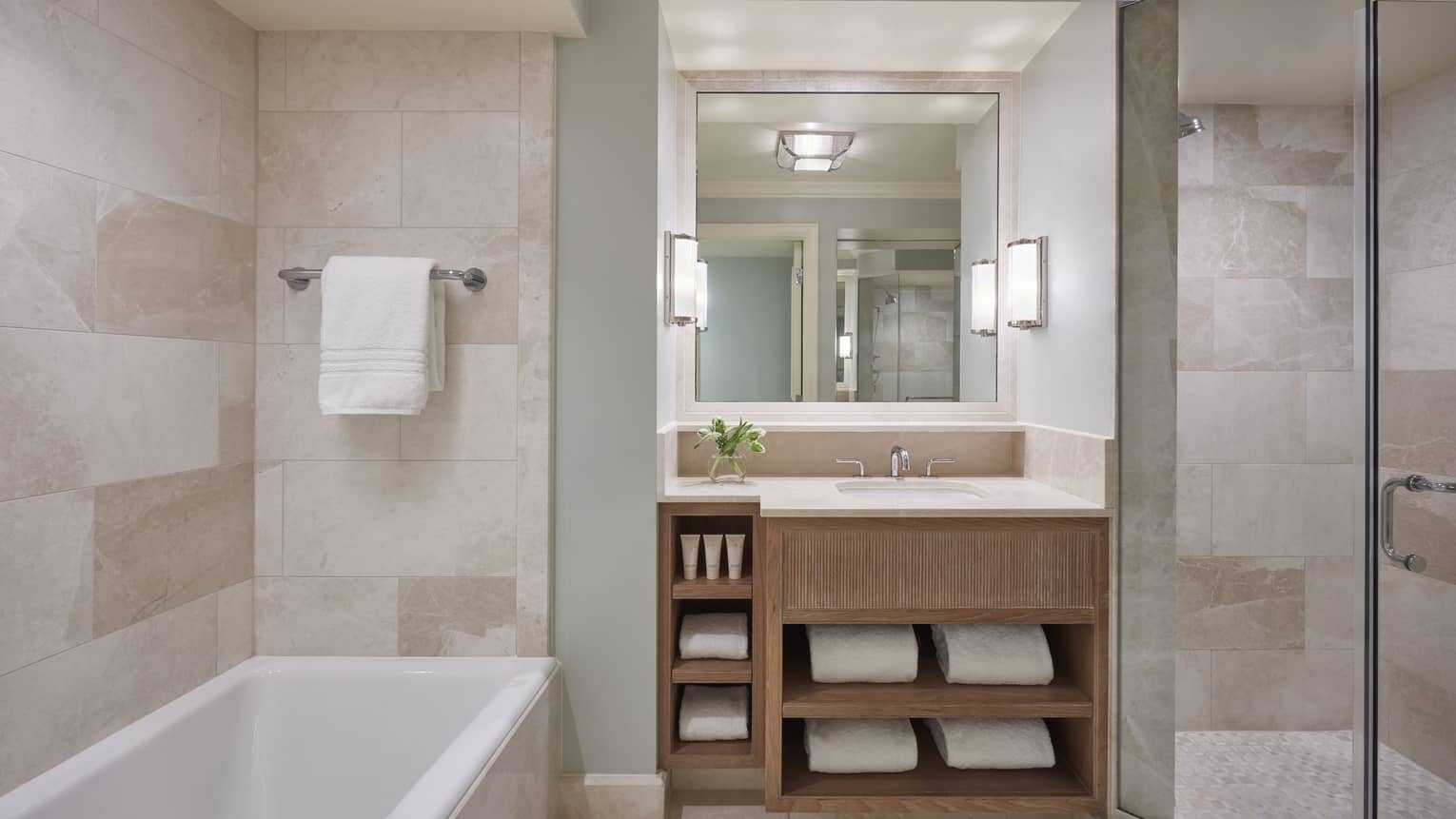 Modern hotel bathroom with a tub and marble walls
